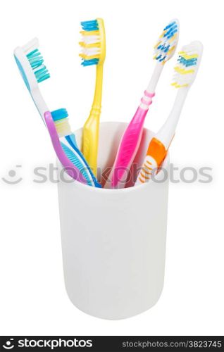 five tooth brushes in ceramic glass - family set of toothbrushes isolated on white background