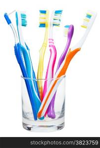 five toothbrushes and interdental brush in clear glass - family set of toothbrushes isolated on white background