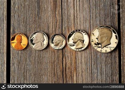 Five US cent coins over wooden background
