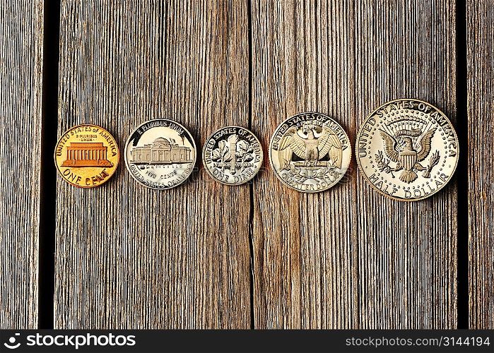 Five US cent coins over wooden background