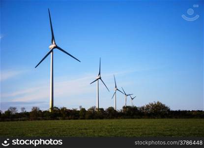 Five wind turbines at blue sky on the swedish island Oland