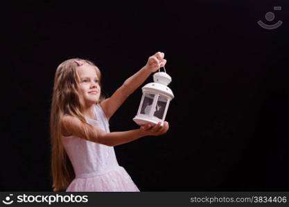 Five year old girl standing with a candlestick