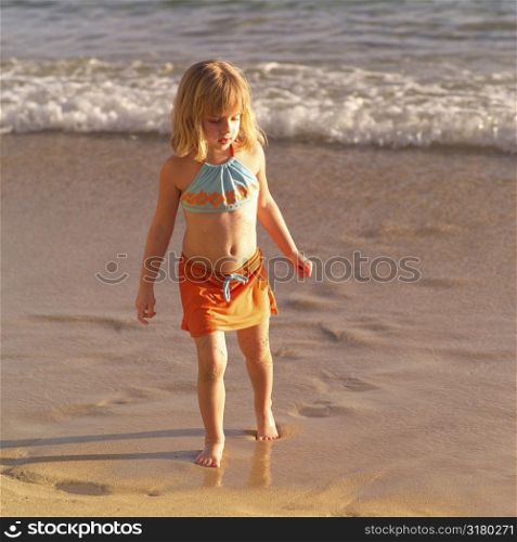 Five year old walking on the beach