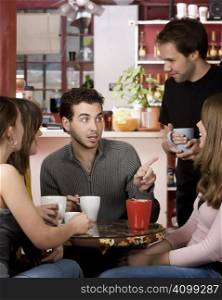 Five young friends in a coffee house