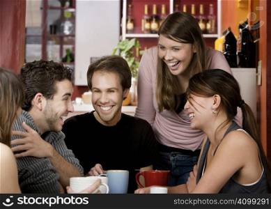 Five young friends in a coffee house