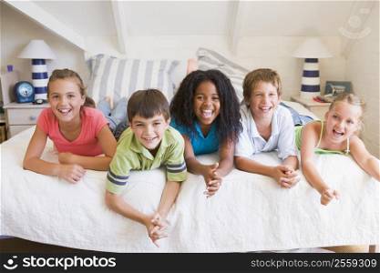 Five Young Friends Lying Down Next To Each Other