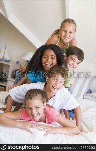 Five Young Friends Lying On Top Of Each Other