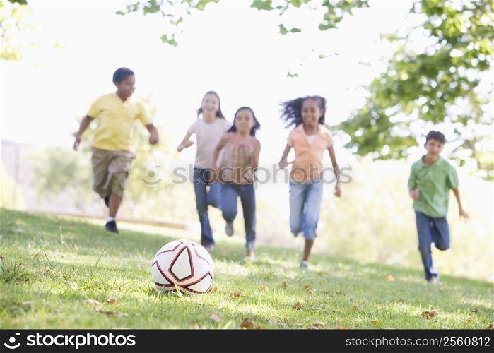 Five young friends playing soccer