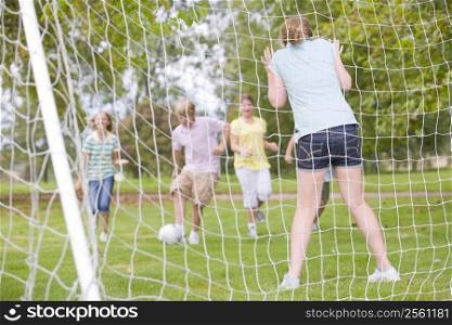 Five young friends playing soccer