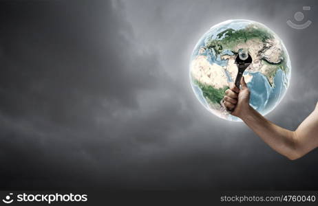 Fixing planet problem. Close up of hand spinning nut on Earth planet. Elements of this image are furnished by NASA