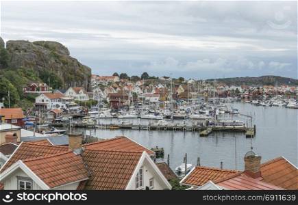 Fjallbacka,Sweden,03-08-2017: people and boats in the harbor of fjallbacka ,this is the touristic hotspot landmark in south sweden. fjallbacka village in sweden