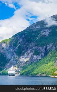 Fjord Geirangerfjord with ferry boat, Norway. Travel cruising.. Ferry boat on fjord in Norway.