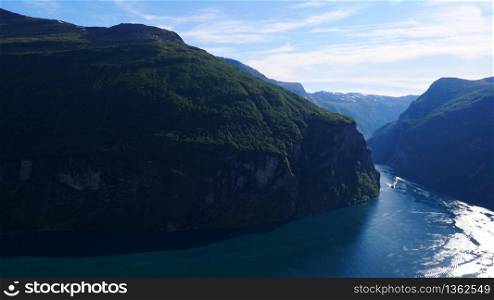 Fjord Geirangerfjord with ferry boat, view from Ornesvingen viewing point, Norway. Travel destination. Fjord Geirangerfjord with ferry boat, Norway.