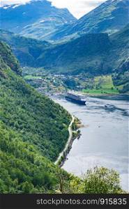 Fjord Geirangerfjord with ferry boat, view from Ornesvingen viewing point, Norway. Travel destination. Fjord Geirangerfjord with ferry boat, Norway.
