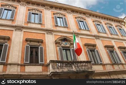 Flag and coat of arms on a building in Rome, Italy