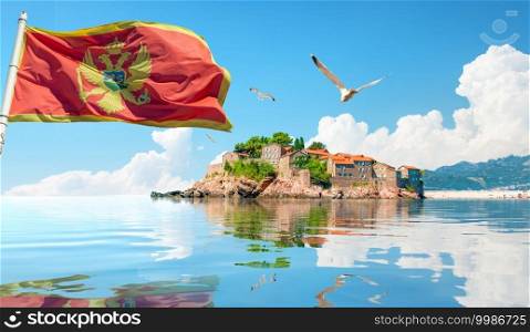 Flag and seagulls and Sveti Stefan island in Montenegro