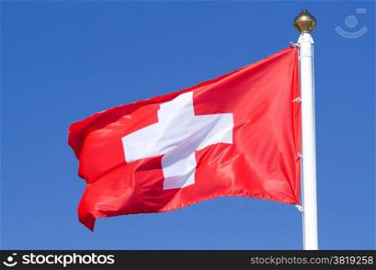 Flag of a Switzerland on a background blue sky