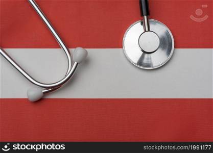 Flag of Austria and stethoscope. The concept of medicine. Stethoscope on the flag in the background.. Flag of Austria and stethoscope. The concept of medicine.