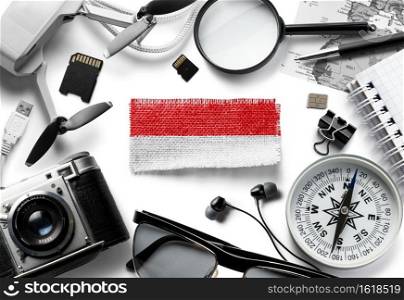 Flag of Indonesia and travel accessories on a white background. The view from the top.. Flag of Indonesia and travel accessories on a white background.