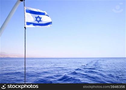 Flag of Israel on the wind, Red sea in the background