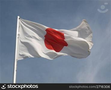 Flag of Japan over a blue sky. Flag of Japan