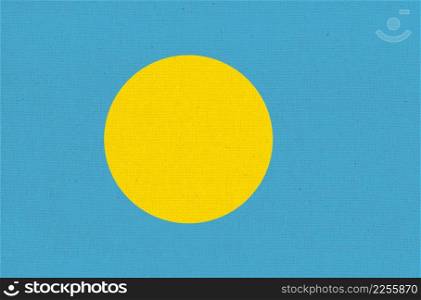Flag of Palau. Palau flag on fabric surface. Fabric Texture. National symbol. Country in Oceania. Republic of Palau. Flag of Palau. Fabric Texture. National symbol