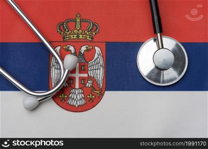 Flag of Serbia and stethoscope. The concept of medicine. Stethoscope on the flag in the background.. Flag of Serbia and stethoscope. The concept of medicine.