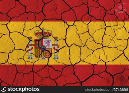 Flag of Spain over cracked background over cracked background, conceptual image of crisis