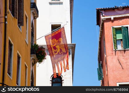 Flag of the Most Serene Republic of Venice on urban house in Venice, Italy