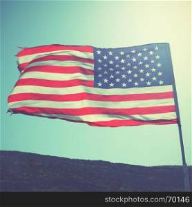 Flag of the United States of America on the wind. Retro style filtered image