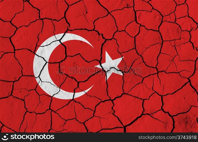 Flag of Turkey over cracked background, conceptual image of crisis