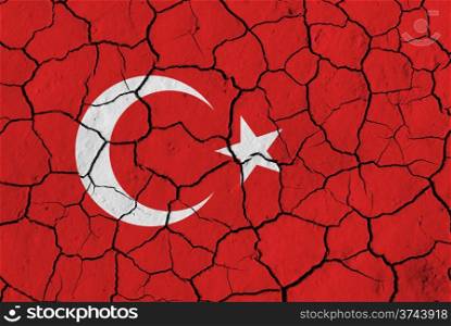 Flag of Turkey over cracked background, conceptual image of crisis