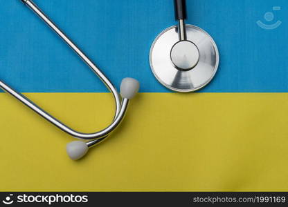 Flag of Ukraine and stethoscope. The concept of medicine. Stethoscope on the flag in the background.. Flag of Ukraine and stethoscope. The concept of medicine.