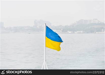 Flag of Ukraine or Ukrainian flag on the background of Dnieper river and Kyiv city, capital of Ukraine.. Flag of Ukraine or Ukrainian flag on the background of Dnieper river and Kyiv city, capital of Ukraine