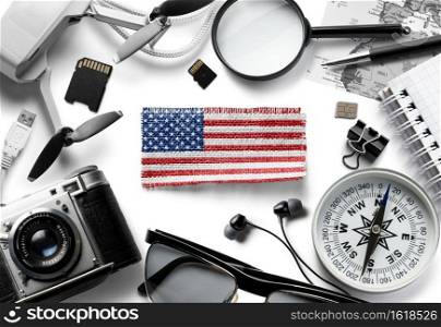 Flag of United States and travel accessories on a white background. The view from the top.. Flag of United States and travel accessories on a white background.
