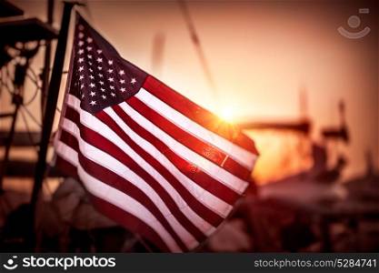 Flag of United States of America flutters in the winds in mild sunset light, independence day of America