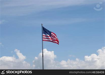 Flag of United States of America waving in the mast with blue sky background&#xA;