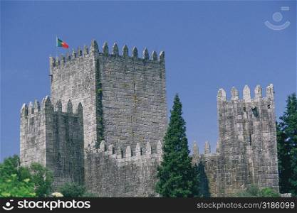 Flag on the top of a castle, Dukes of Braganca Palace, Guimaraes, Minho, Portugal
