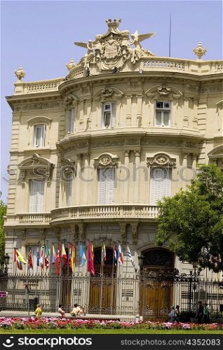 Flags in front of a palace, Palacio de Linares, Plaza de Cibeles, Madrid, Spain