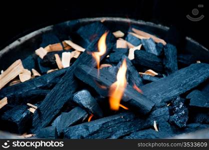 Flame and charcoal in a bbq grill