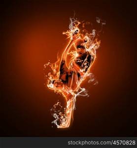 Flame and fire dancer against black background