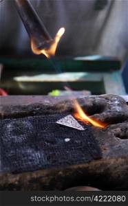 Flame in workshop of silver craftsman, Sumatra, Indonesia