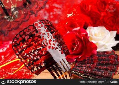 Flamenco comb fan and roses typical from Spain Espana on red background