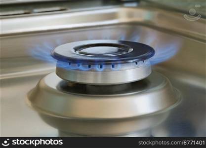 Flames of gas stove, closeup, indoors shot, natural gas