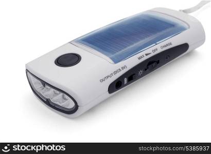 Flashlight on a solar battery, charger and FM radio isolated on white