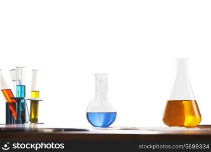 Flask , beaker and test tubes on table isolated over white background