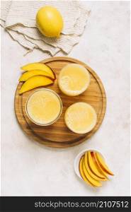 flat lay arrangement fresh smoothies sliced mango