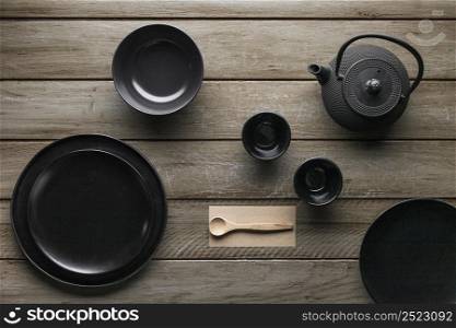 flat lay assortment dinnerware with teapot wooden spoon