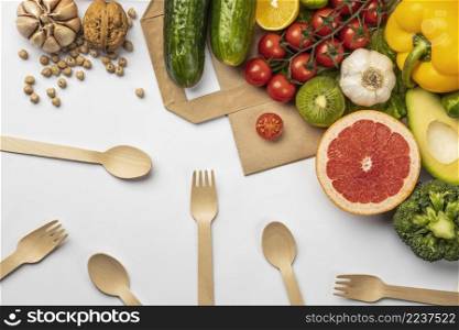 flat lay assortment vegetables with paper bag wooden cutlery