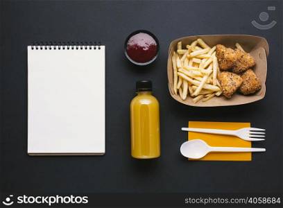flat lay assortment with fries notebook